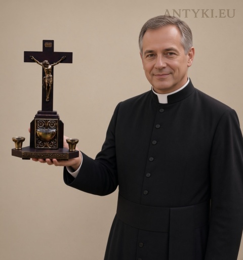 krucyfiks z kropielnicą na wodę święconą trzymany przez księdza
