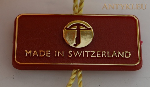 metka rondla z napisem Made in Switzerland i znakiem producenta